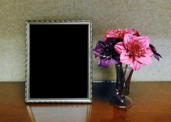 blank picture frame next to flowers